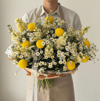 Mother’s Day bouquet with chamomile daisies and yellow flowers in a natural meadow-style arrangement