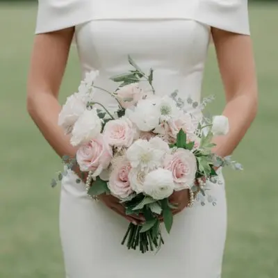 Pink wedding bouquet with blush roses, white flowers, eucalyptus and greenery for elegant bridal wedding ceremony