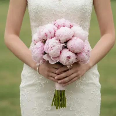 Pink wedding bouquet with premium blush peonies in a classic round bridal arrangement with satin ribbon