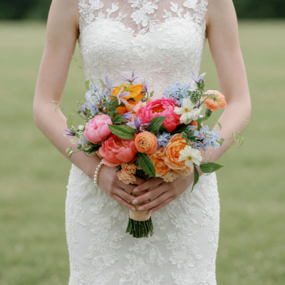 Popular wedding bouquets with coral, peach, pink and blue garden flowers arranged as a colourful bridal bouquet.