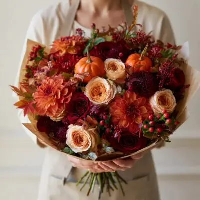 Fall flowers Vancouver bouquet with peach roses, burgundy and rust flowers, red berries, eucalyptus and miniature orange pumpkins.