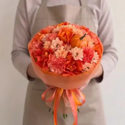 Orange flowers Vancouver Pumpkin Spice bouquet with orange roses, coral carnations, peach flowers and miniature pumpkins in tonal wrapping.