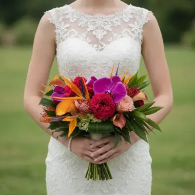 popular wedding bouquets with magenta orchids orange bird of paradise crimson flowers peach roses calla lilies and glossy tropical foliage