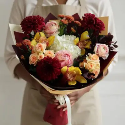 Luxury flowers Vancouver Sinful Nectar bouquet with burgundy chrysanthemums, yellow orchids, peach roses, blush ranunculus and white hydrangea.