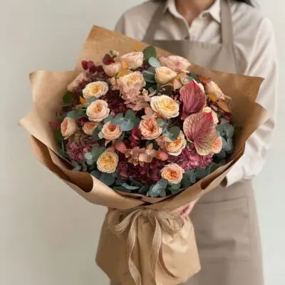Luxury autumn bouquet Vancouver with peach spray roses, burgundy hydrangea, pink anthurium and silvery eucalyptus wrapped in kraft paper