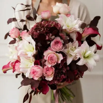 Romantic flower delivery Vancouver bouquet with pink roses, white blooms, burgundy hydrangea, deep pink calla lilies and dark foliage