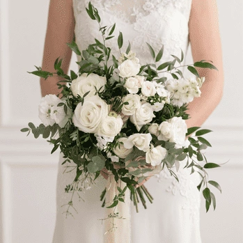 White Wedding Bouquet with white roses, white lisianthus, eucalyptus, and fresh greenery arranged in a romantic garden-style bridal bouquet.