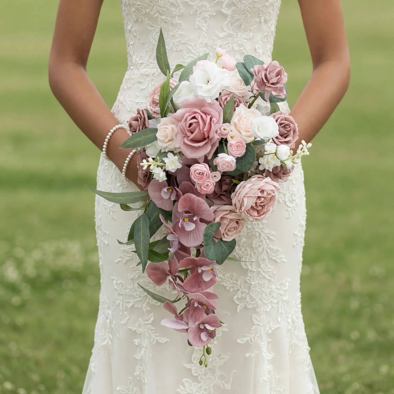 Pink Wedding Bouquet with dusty rose roses, blush spray roses, cascading orchids, ivory flowers, and eucalyptus bridal blooms