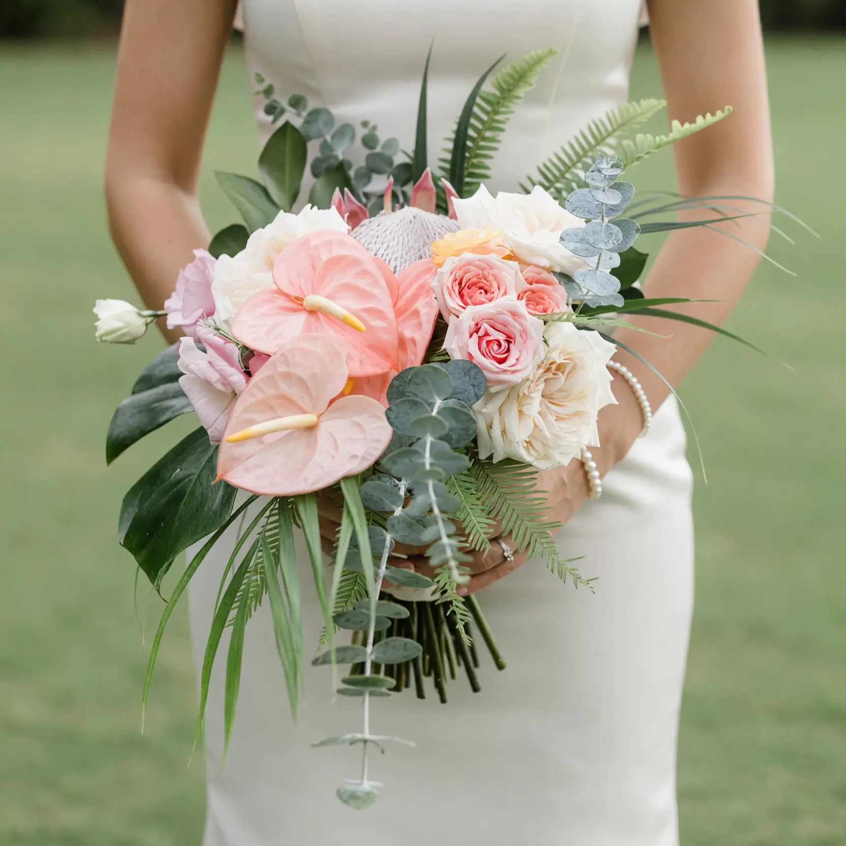 Pink Wedding Bouquet bridal flowers bouquets with blush anthuriums, king protea, garden roses, eucalyptus, tropical leaves, and palm foliage