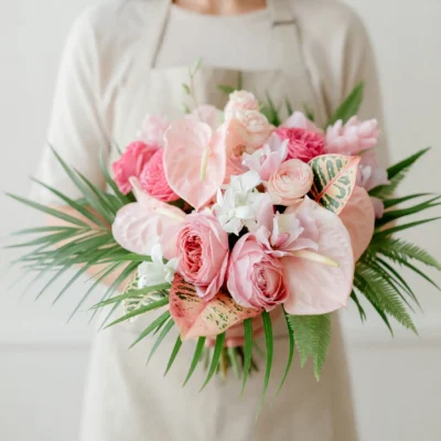 Pink Wedding Bouquet bridal flowers bouquets with blush anthuriums, garden roses, peonies, ranunculus, tropical leaves, palm fronds, and lush greenery