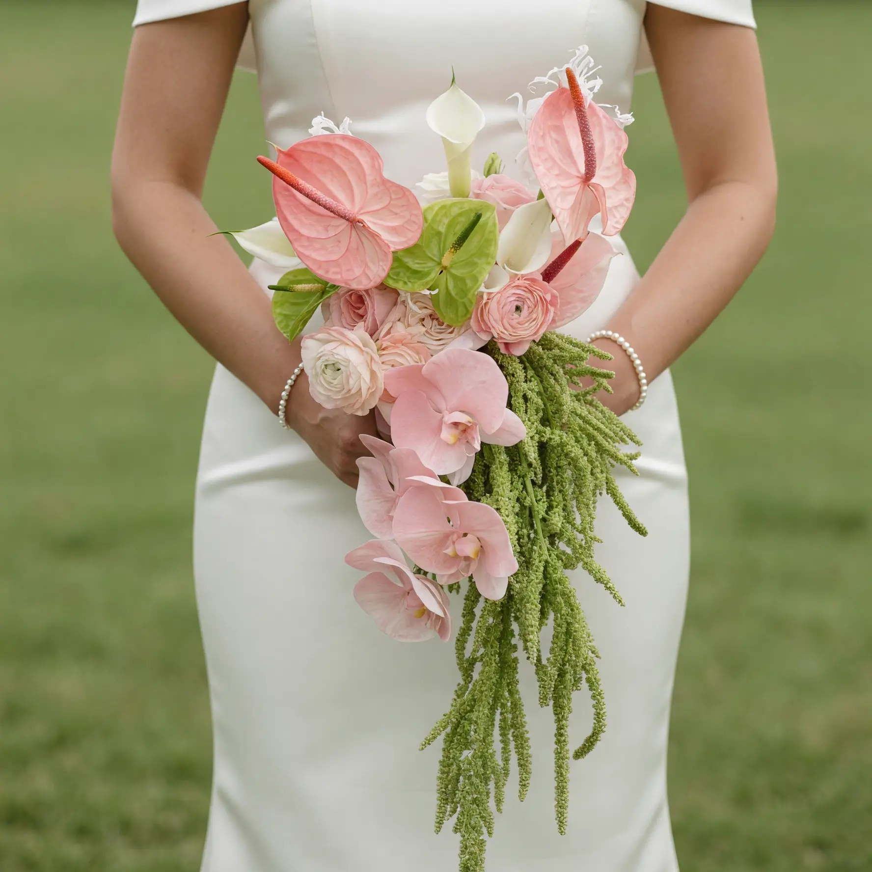 Boho style flowers Blush Cascade Pink Wedding Bouquet with blush orchids, pink anthuriums, calla lilies, ranunculus, roses, green anthuriums, and cascading amaranthus