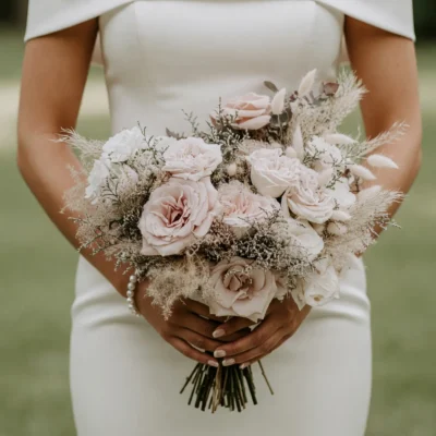 Boho style flowers pink wedding bouquet with blush garden roses, preserved grasses, ivory blooms, and elegant bridal floral arrangement