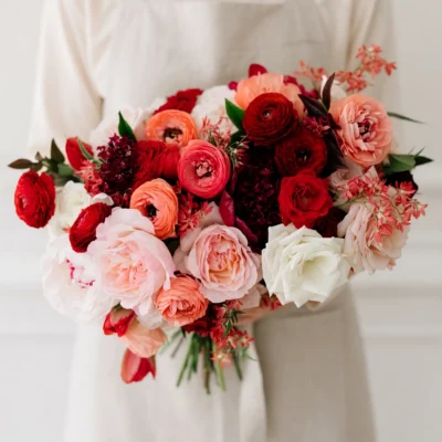Red Wedding Bouquet with blush garden roses, crimson ranunculus, white roses, peonies, and elegant bridal flowers bouquets