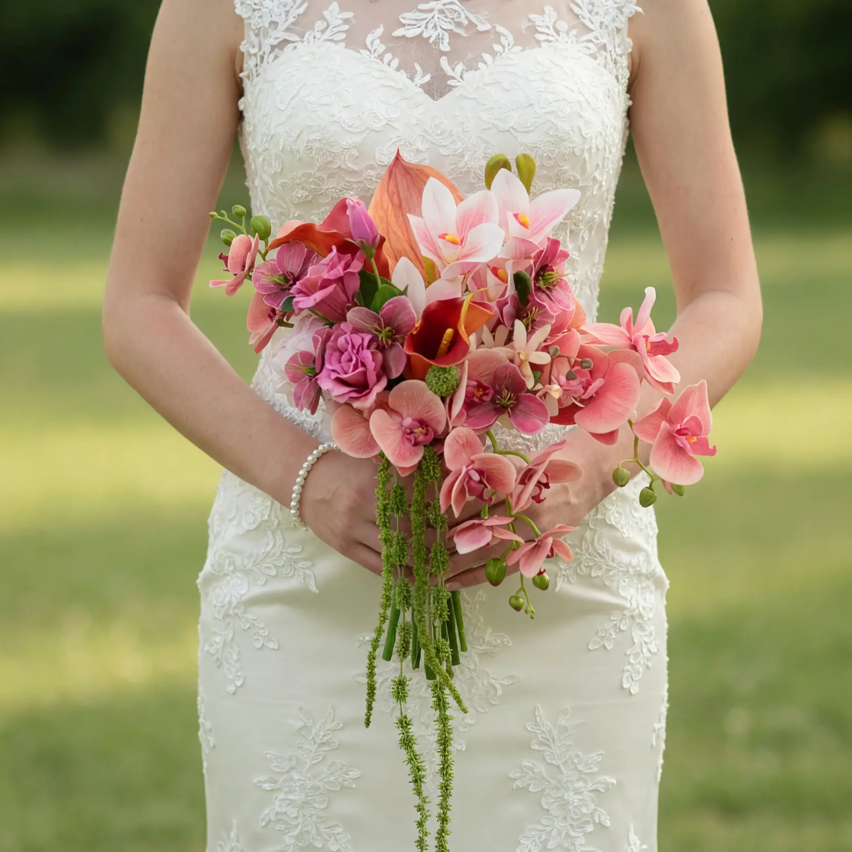 Beach Wedding Bouquets featuring pink orchids, pink roses, coral calla lilies, berry blooms, and cascading green amaranthus