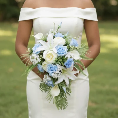 Beach Wedding Bouquets featuring soft blue roses, white lilies, ivory calla lilies, delicate white flowers, and cascading tropical palm foliage