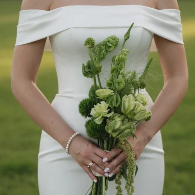 Bridal flowers bouquets with sage green blooms, green chrysanthemums, flowering spikes, and cascading amaranthus for elegant weddings