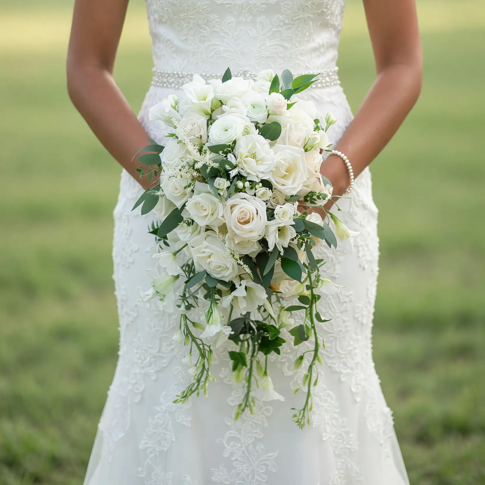 Popular wedding bouquets with cascading ivory roses, white flowers, eucalyptus greenery, and elegant bridal floral design.