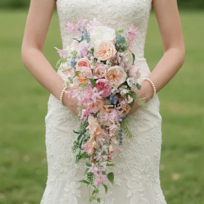 Popular wedding bouquets with cascading blush roses, pastel flowers, blue floral accents, and elegant greenery for romantic bridal weddings.