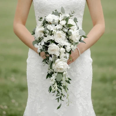 Bridal flowers bouquets with cascading white roses, eucalyptus greenery, delicate white blossoms, and elegant wedding floral design.
