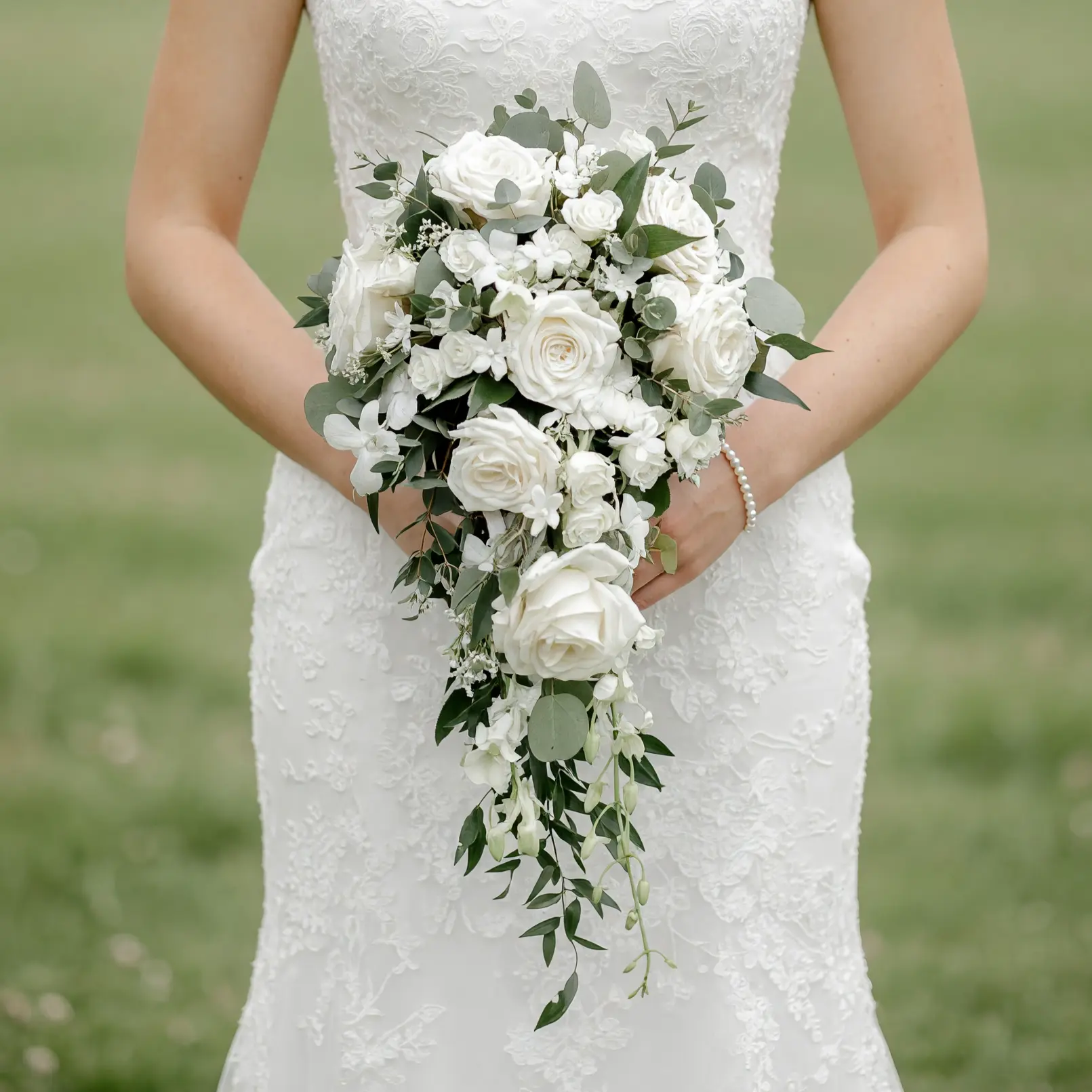 Bridal flowers bouquets with cascading white roses, eucalyptus greenery, delicate white blossoms, and elegant wedding floral design.