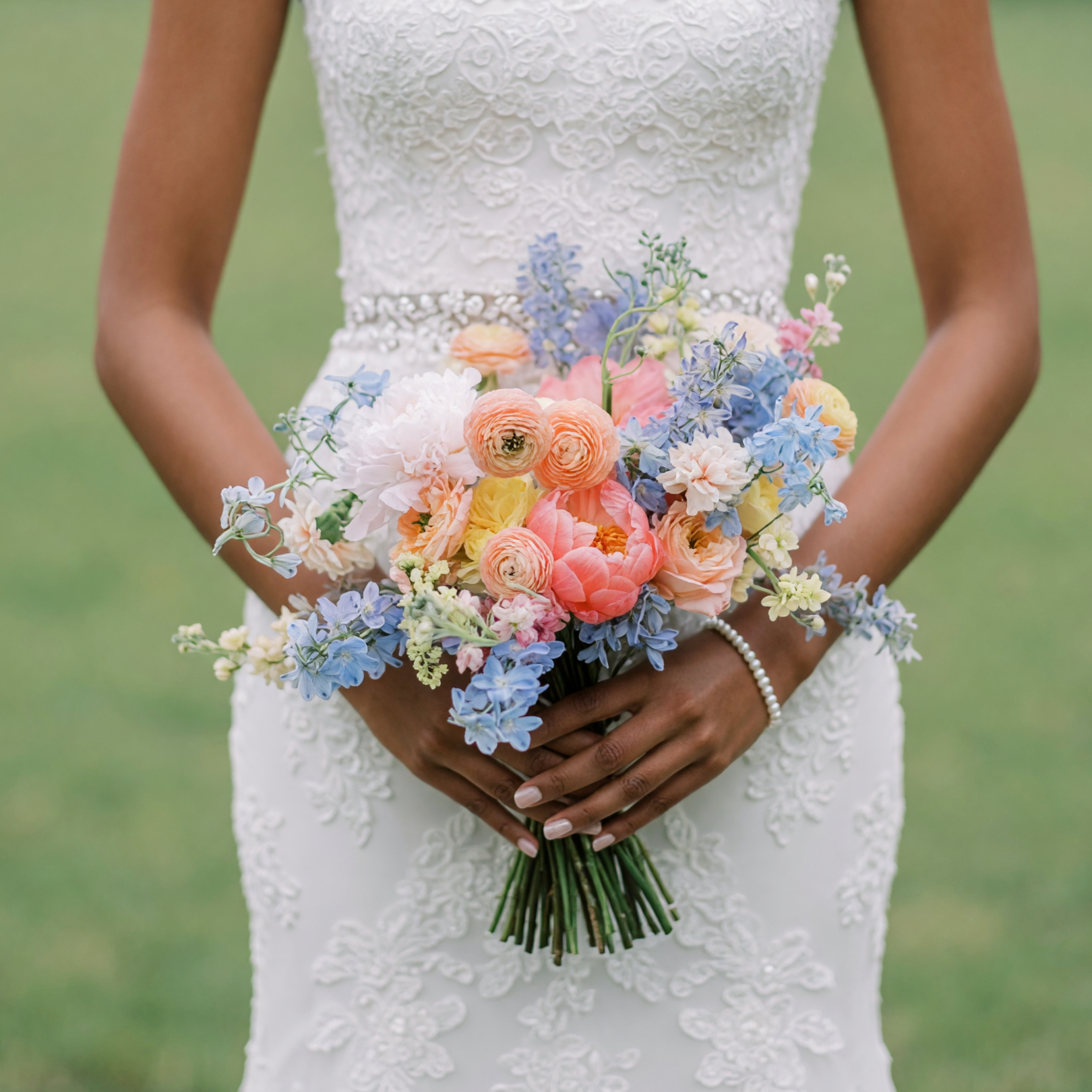 Bridal flowers bouquets with powder blue, peach, coral, ivory and yellow flowers for a romantic colourful wedding bouquet.