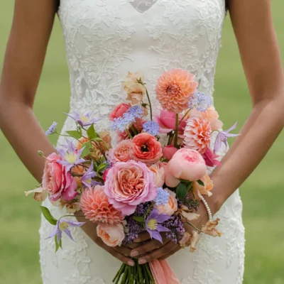 Bridal flowers bouquets with peach dahlias, blush garden roses, pink peonies, lavender flowers and soft blue accents for a romantic wedding.