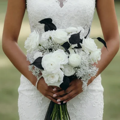 Popular wedding bouquets featuring white roses, white flowers, black foliage and baby's breath for an elegant black and white bridal bouquet
