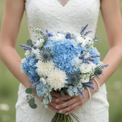popular wedding bouquets with soft blue hydrangeas white dahlias creamy roses lavender accents and eucalyptus held by a bride
