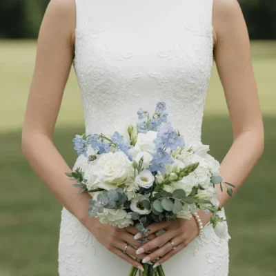 Budget wedding bouquets with white roses pale blue flowers eucalyptus and delicate greenery for a romantic bridal celebration