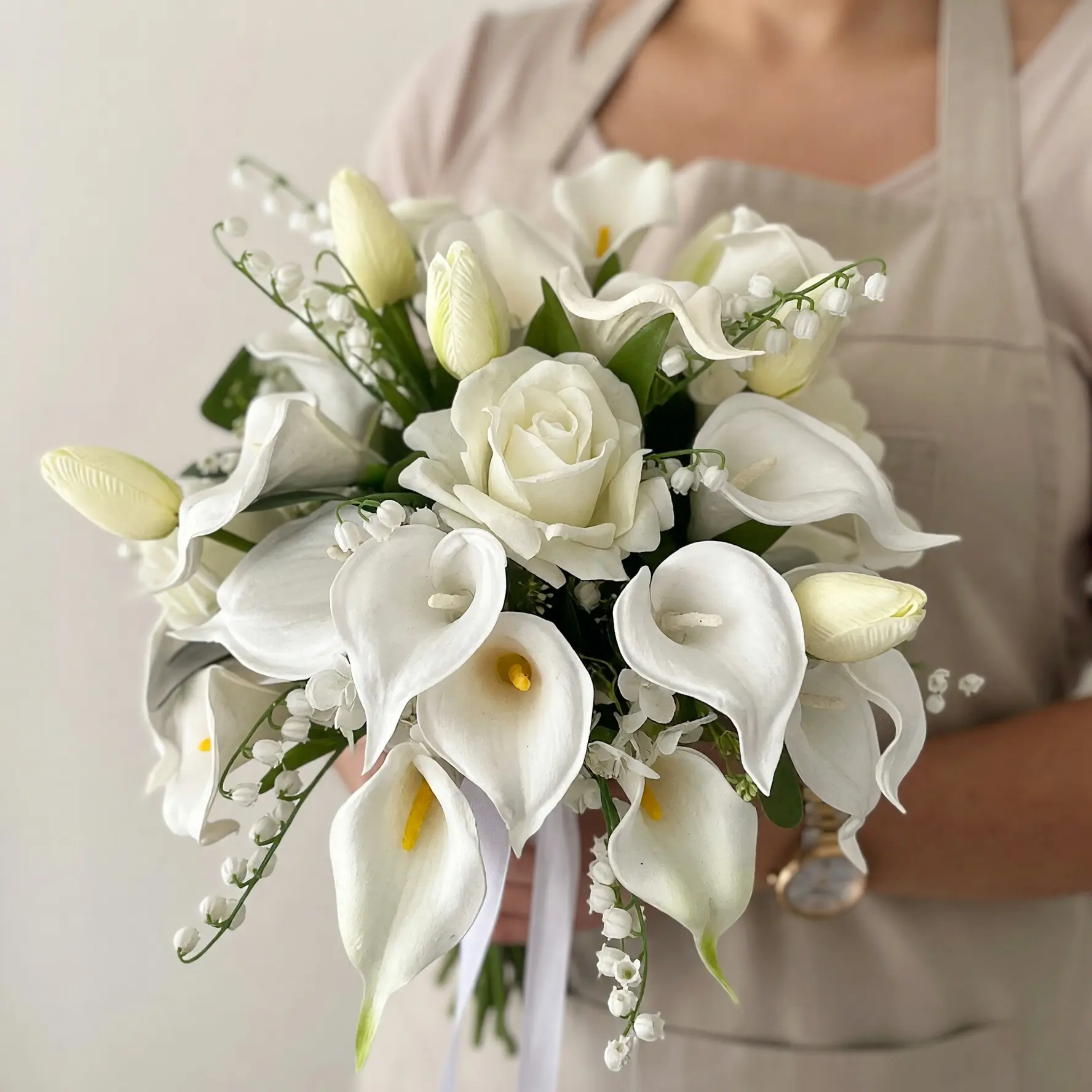 Bridal flowers bouquets with white calla lilies, creamy roses, tulips, and delicate cascading wedding flowers