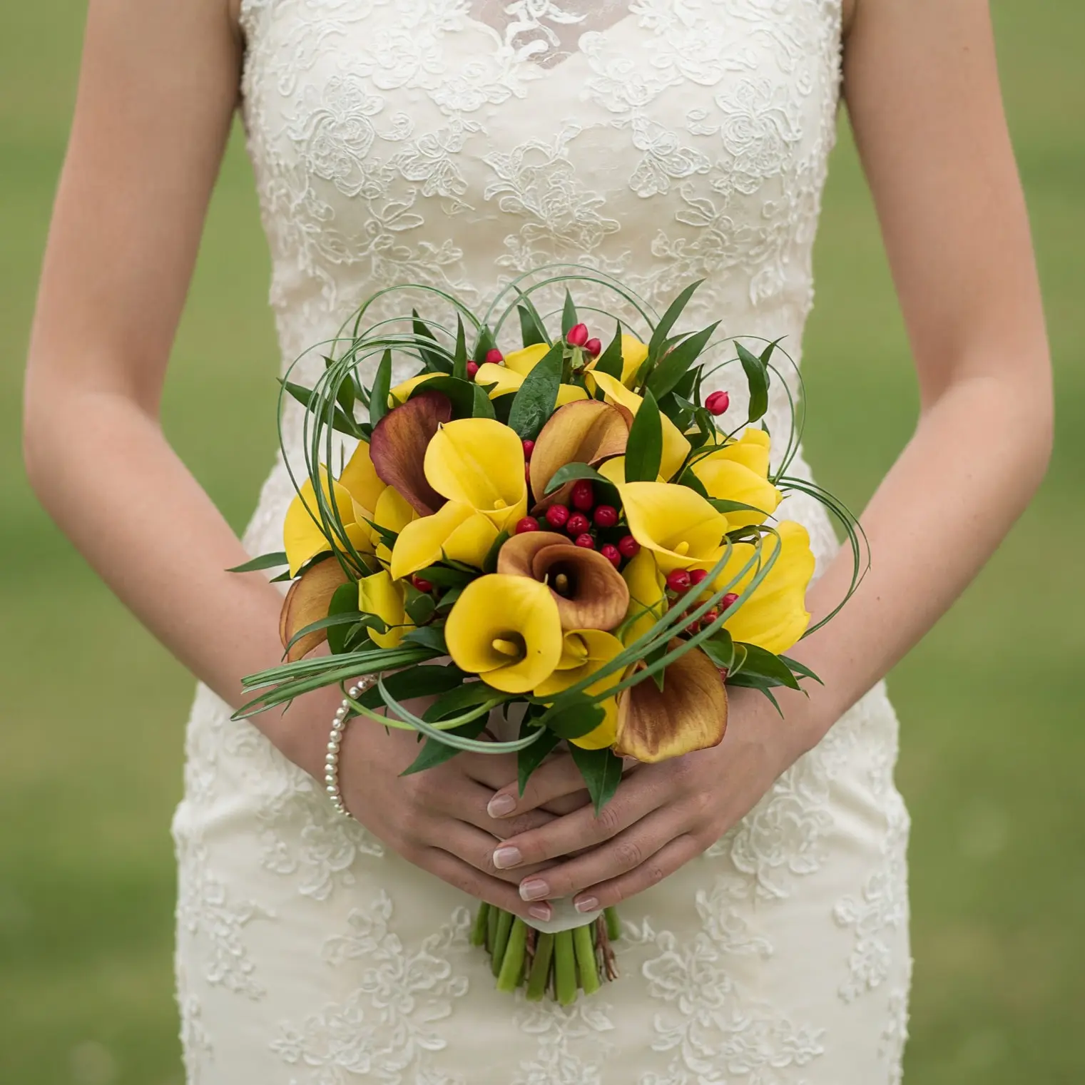 Popular wedding bouquets with yellow and brown calla lilies, red berries, and flowing greenery for a colourful bridal wedding bouquet