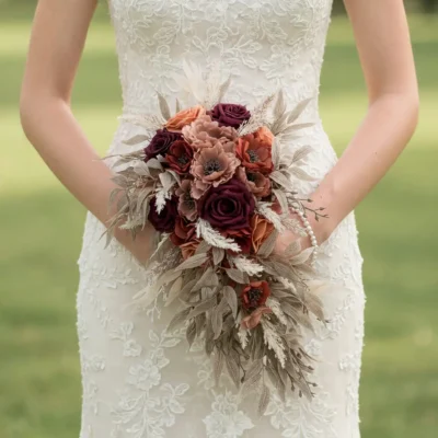Bridal flowers bouquets with merlot roses, dusty peach blooms, taupe foliage, pale feathery accents, and soft cascading greenery for a fall bride