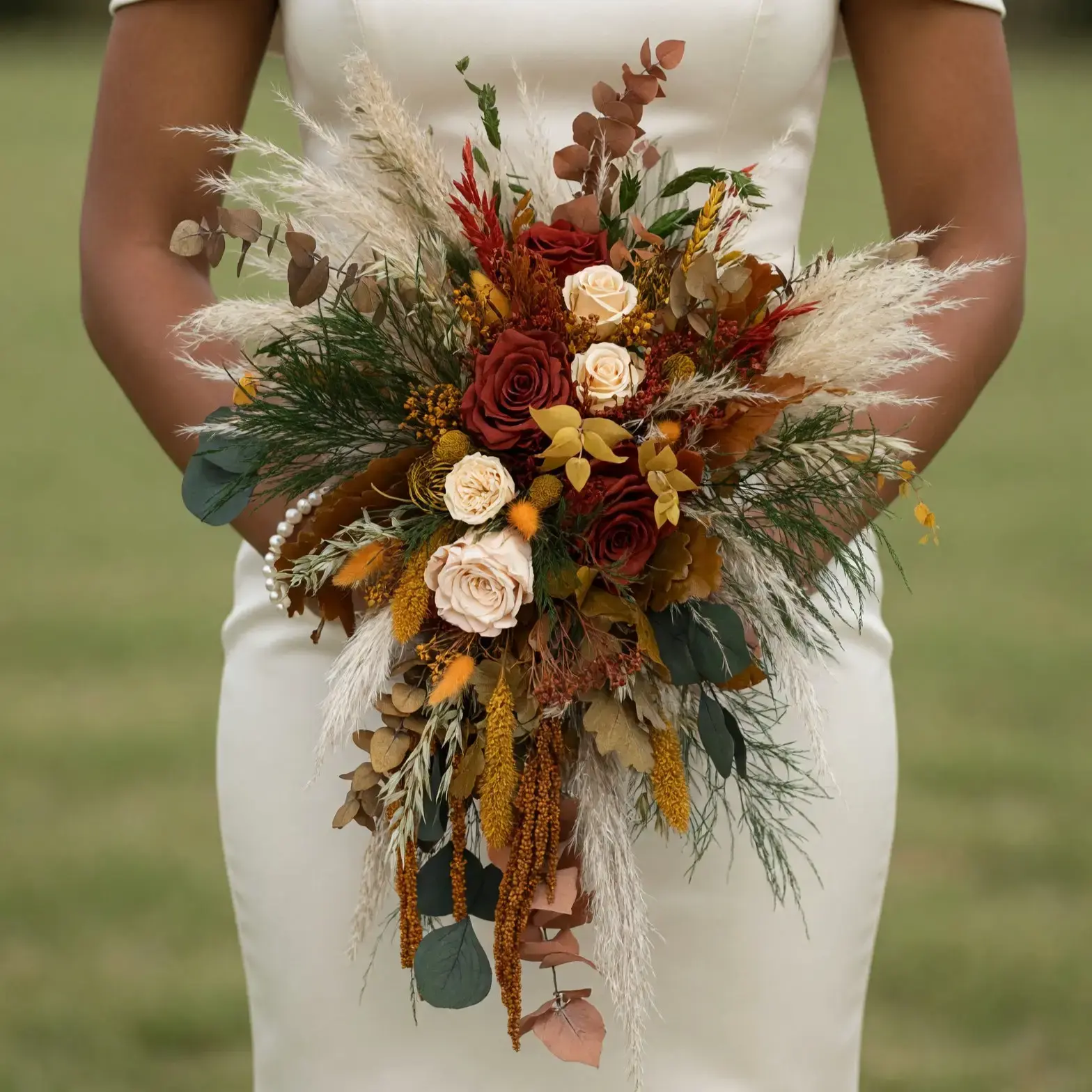 Popular wedding bouquets with rust roses, ivory flowers, pampas grass, golden amaranthus, eucalyptus, and warm foliage for a fall bride