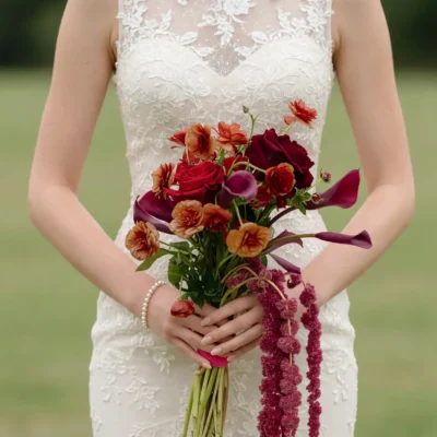 Bridal flowers bouquets with burgundy roses, plum calla lilies, copper flowers, raspberry amaranthus, and fresh greenery for a fall wedding