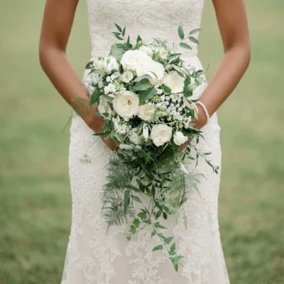 wedding bouquet cost inspiration with ivory roses white flowers eucalyptus fern textures and cascading greenery for a garden bride