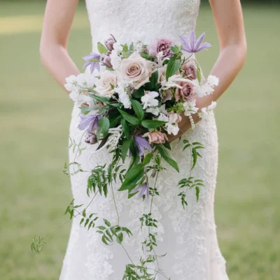 bridal blooms with dusty mauve roses lavender flowers ivory blossoms and long trailing greenery for a romantic garden wedding