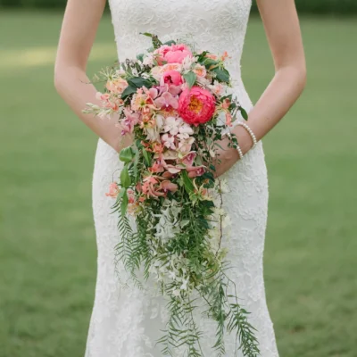 bridal flowers bouquets with coral peonies blush orchids ivory flowers fern fronds and long cascading greenery for a romantic garden wedding