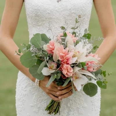 boho style flowers bridal bouquet with blush pink tropical blooms white orchids eucalyptus silver filler and airy green foliage