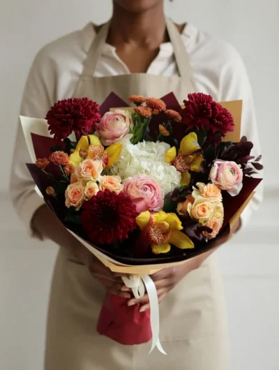 Luxury flowers Vancouver Sinful Nectar bouquet with burgundy chrysanthemums, yellow orchids, peach roses, blush ranunculus and white hydrangea.